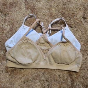 Pair of padded bralettes, nude and white.